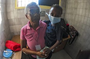 Desperate: Nury Gonzalez holds her undernourished grandson in a hospital in Maracay