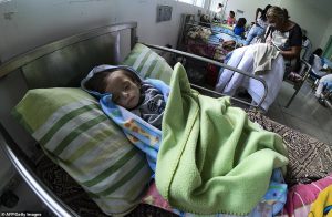 Heartbreaking: A young malnourished child lies in bed in a hospital called Los Samanes, in the city of Maracay, about 62miles from the capital Caracas